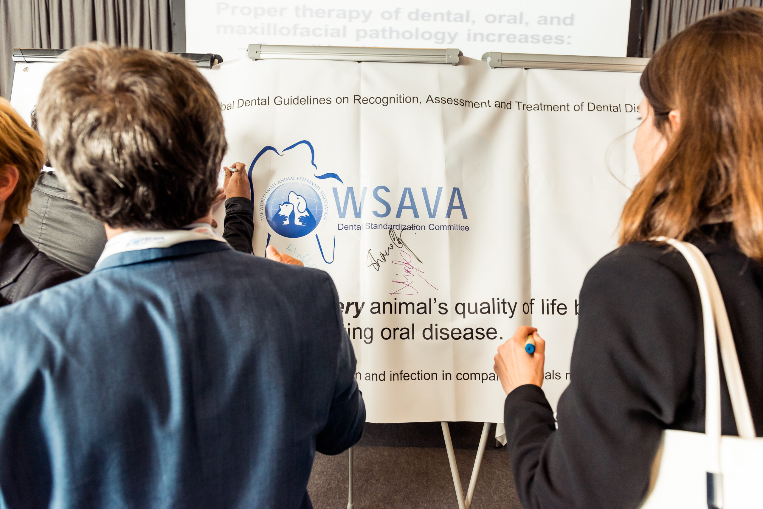 Attendees signing the document