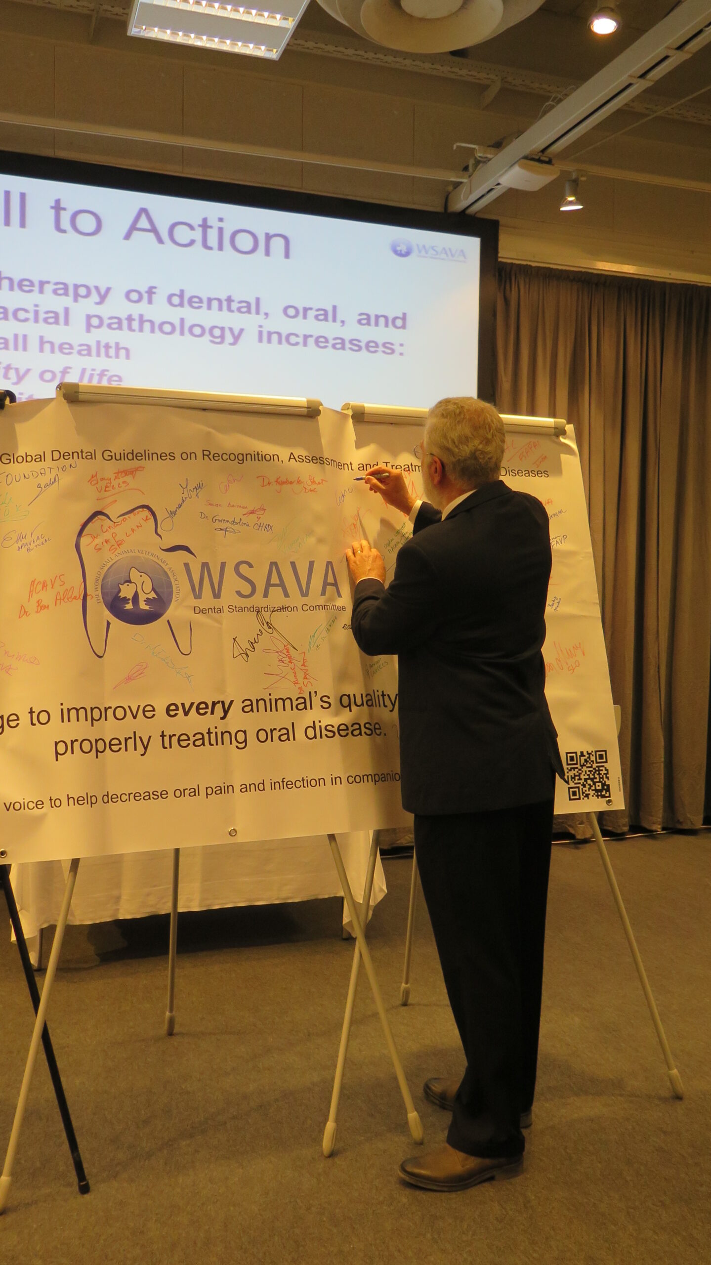 Committee member Dr. Cedric Tutt signing the banner