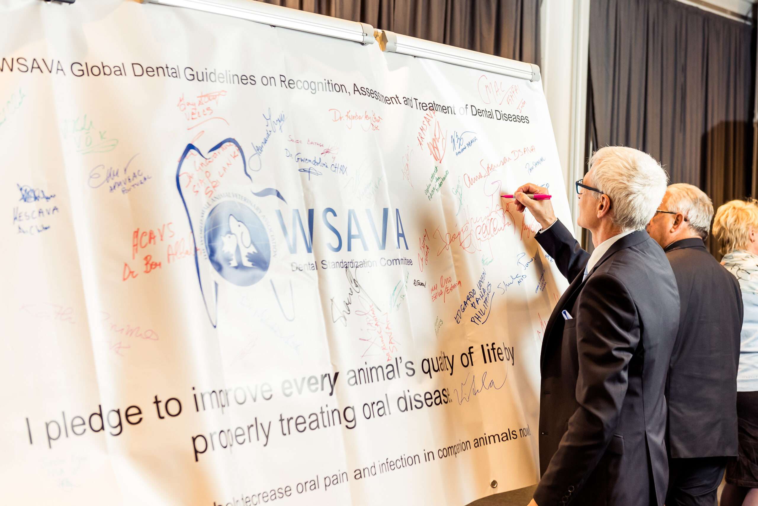 Committee member Gottfreid Mortenegg signing the banner